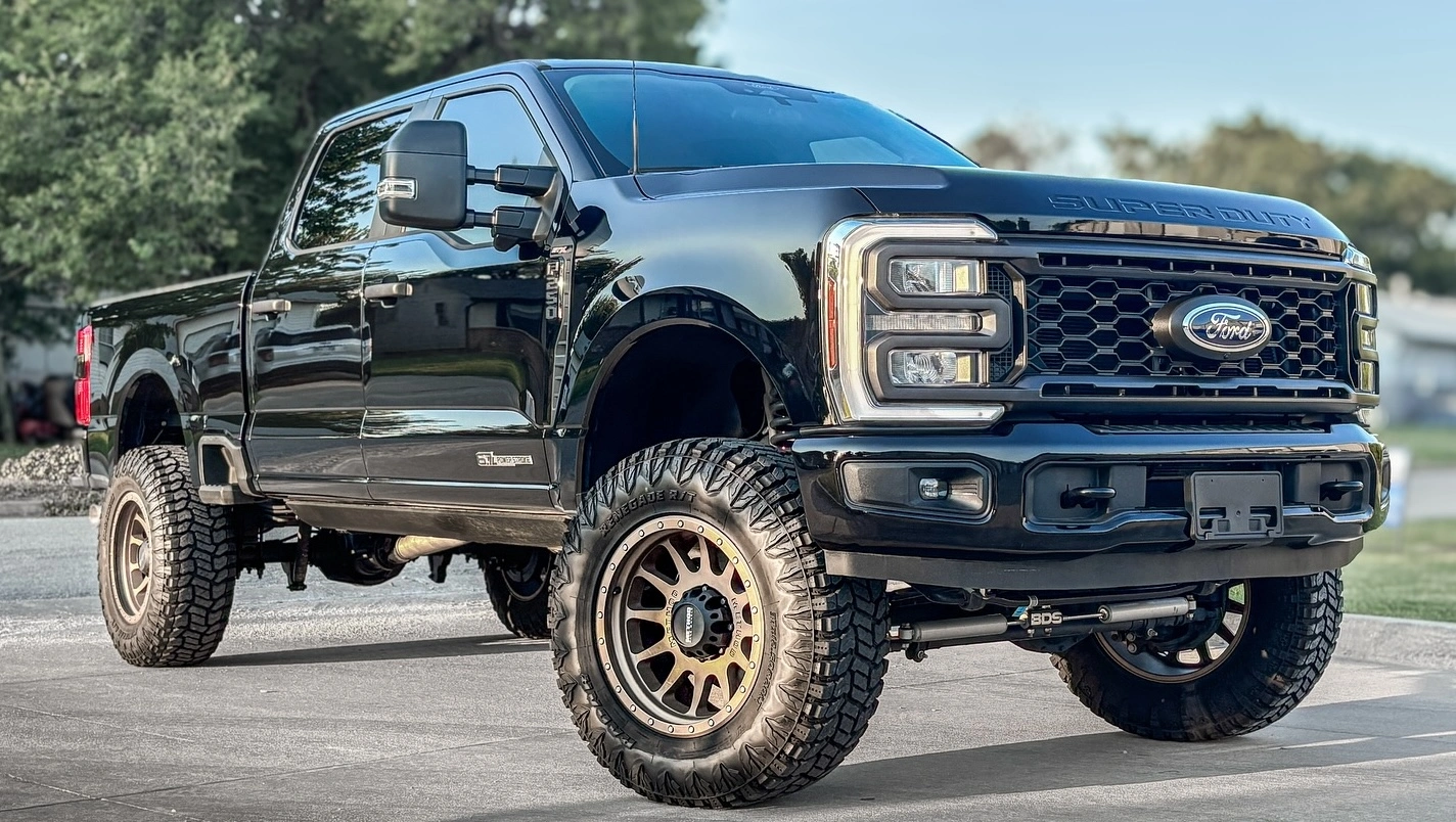 Woman smiles leaning out of car